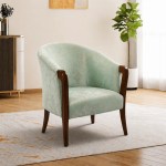 Green fabric lounge chair in a room