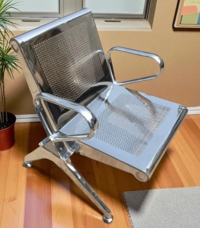 tainless steel one seater waiting chair in silver color placed in modern indoor room with wooden flooring