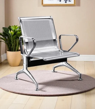 Single seater waiting chair with chrome finish metal frame and perforated design